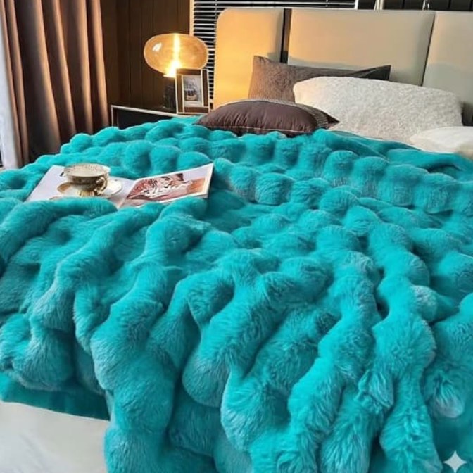 Cobija burbuja piel de ángel turquesa sobre cama
