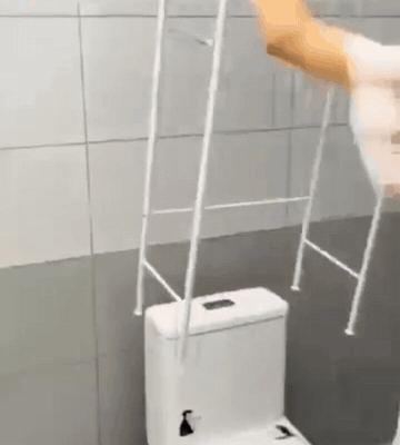 Mujer armando el estante blanco encima del sanitario