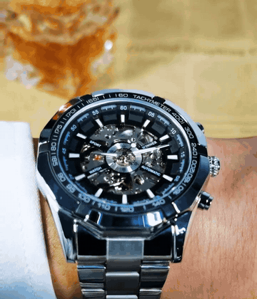 Primer plano del reloj Winner skeleton mostrando el mecanismo y el bisel tachymeter